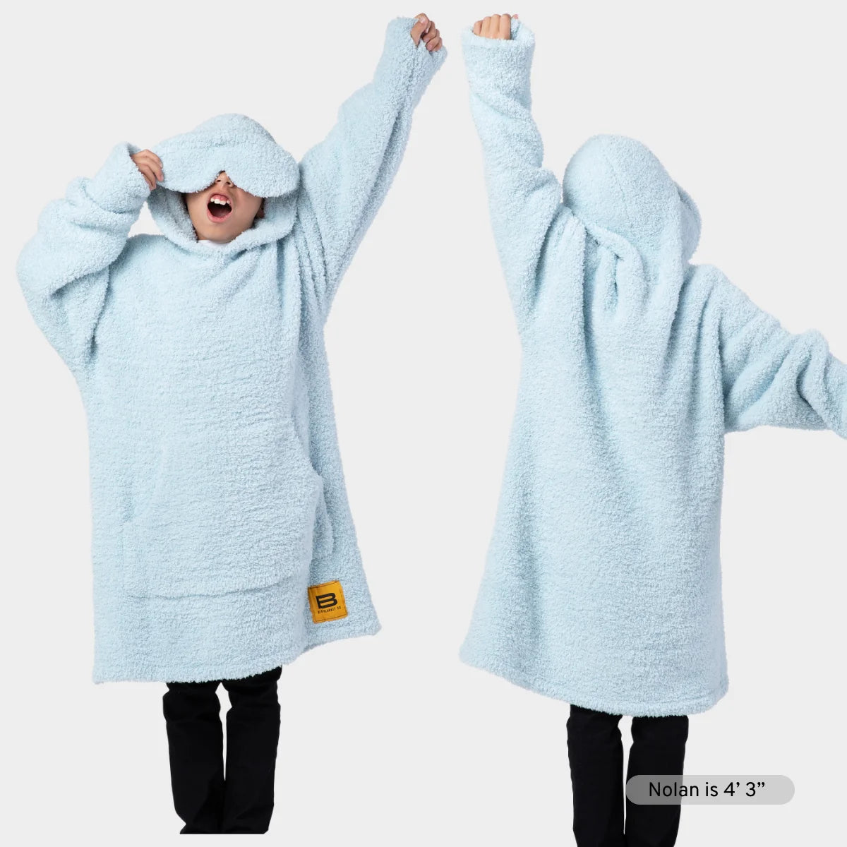 Sky blue oversized hoodie blanket with kangaroo pocket and matching hood, worn by model showing front and side views