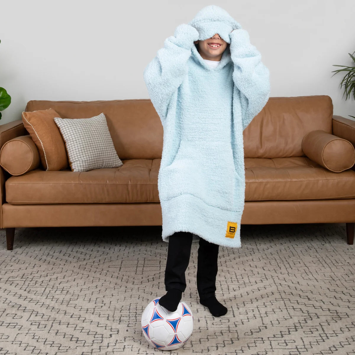 Soft sky blue oversized hoodie blanket with plush texture and vertical seam details