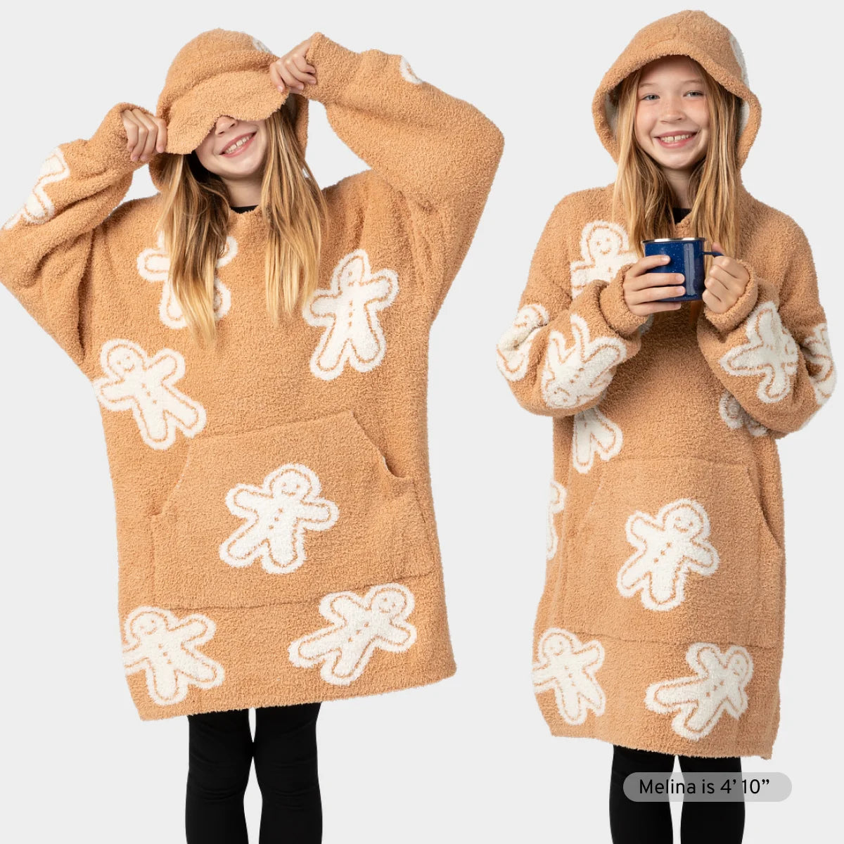 Tan oversized hoodie blanket with white gingerbread man pattern, shown front and back on model wearing matching socks
