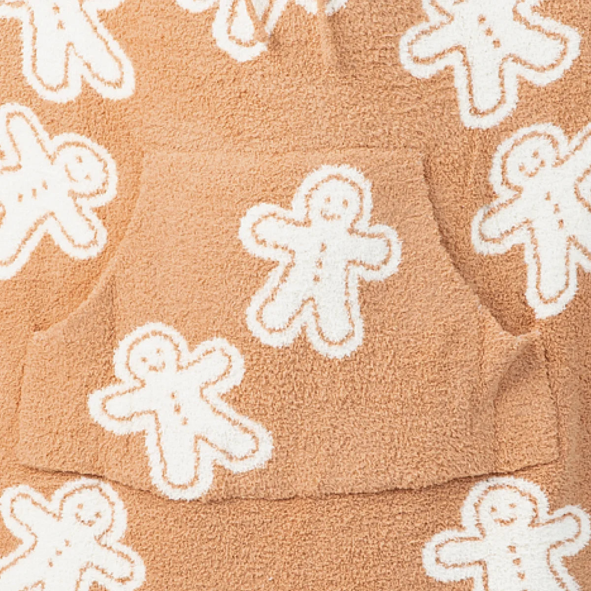 Tan oversized blanket with white gingerbread man pattern, cozy plush texture throughout