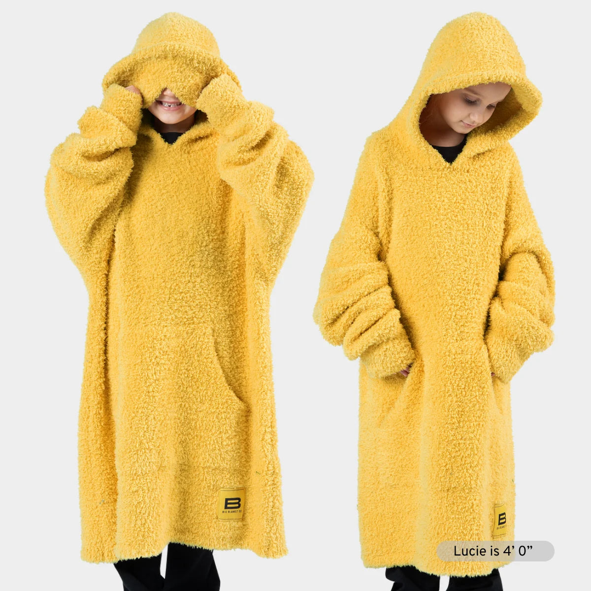 Woman modeling bright yellow oversized hoodie blanket with cozy texture and large hood in two poses