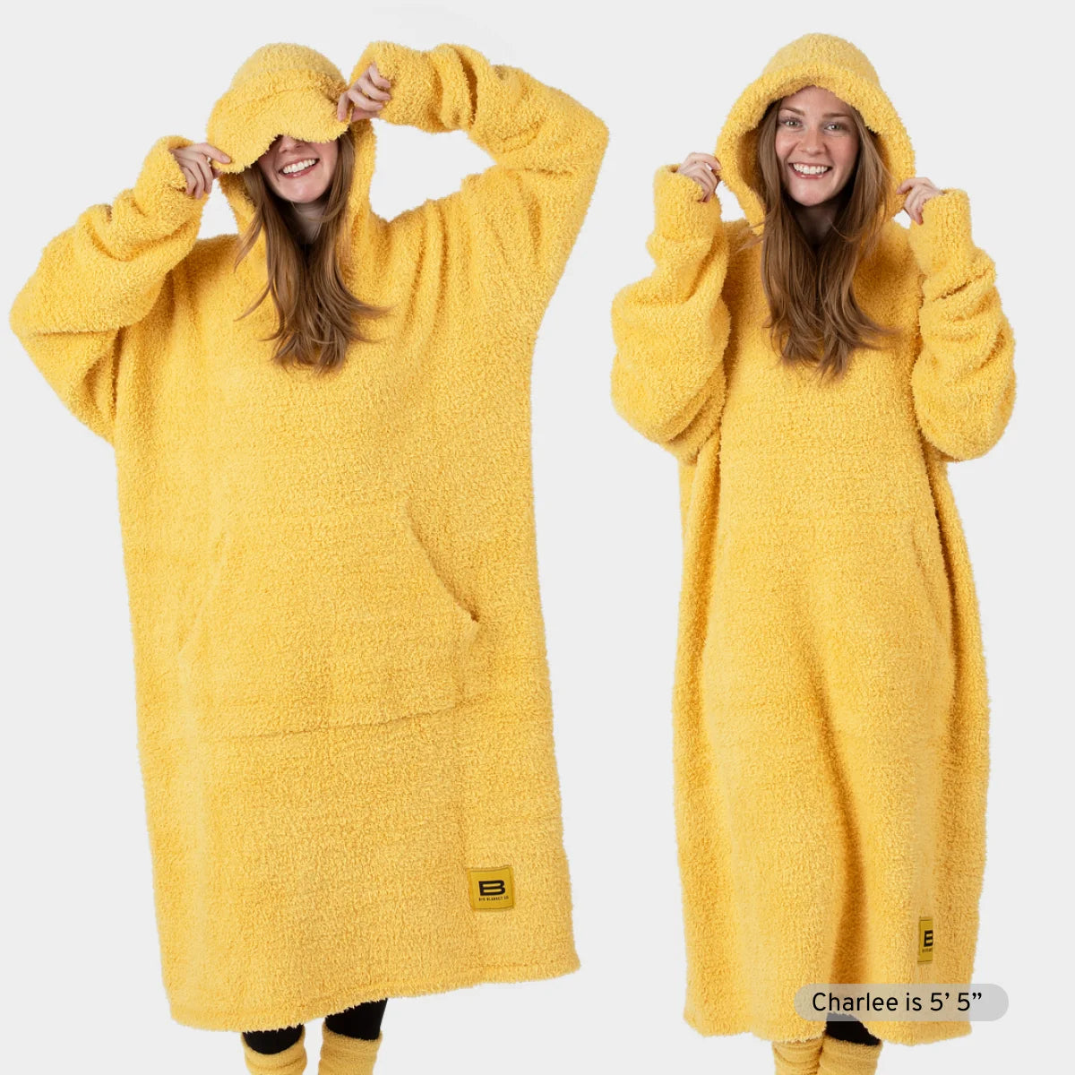 Woman wearing oversized yellow Premier Plush Hoodie with hood up, shown front and side views demonstrating roomy fit and soft texture