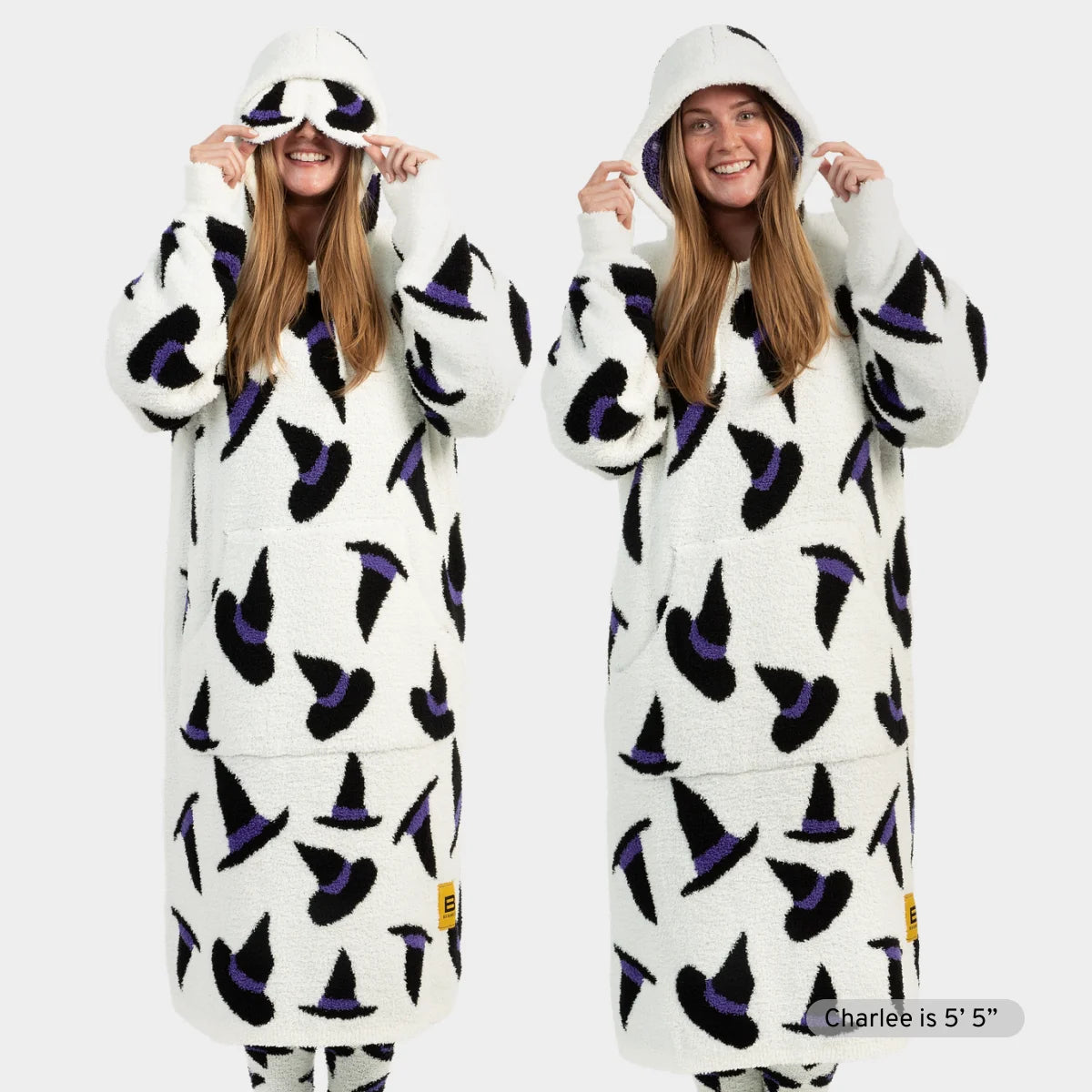 Woman wearing cream Premier Plush hoodie with black and purple witch hat pattern, matching hood with eye cutouts pulled over head