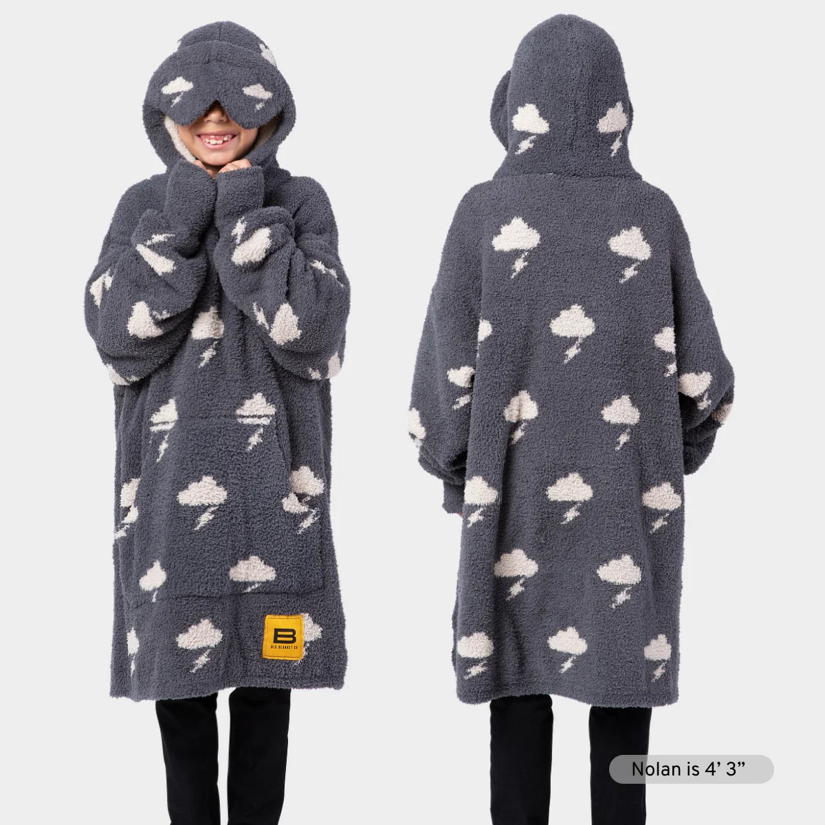 Child wearing gray Premier Plush Kids Hoodie with cloud and lightning bolt pattern, hood covering head with white eye patches, front and back views