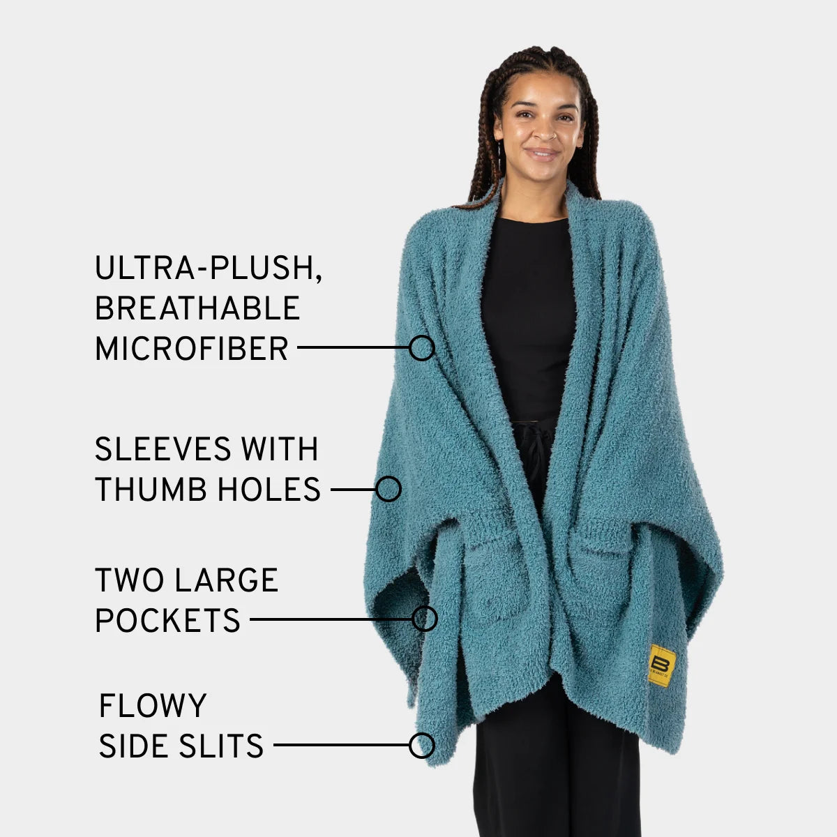 Aqua Premier Plush™ Wrap worn as oversized blanket with sleeves, thumb holes, pockets, and side slits