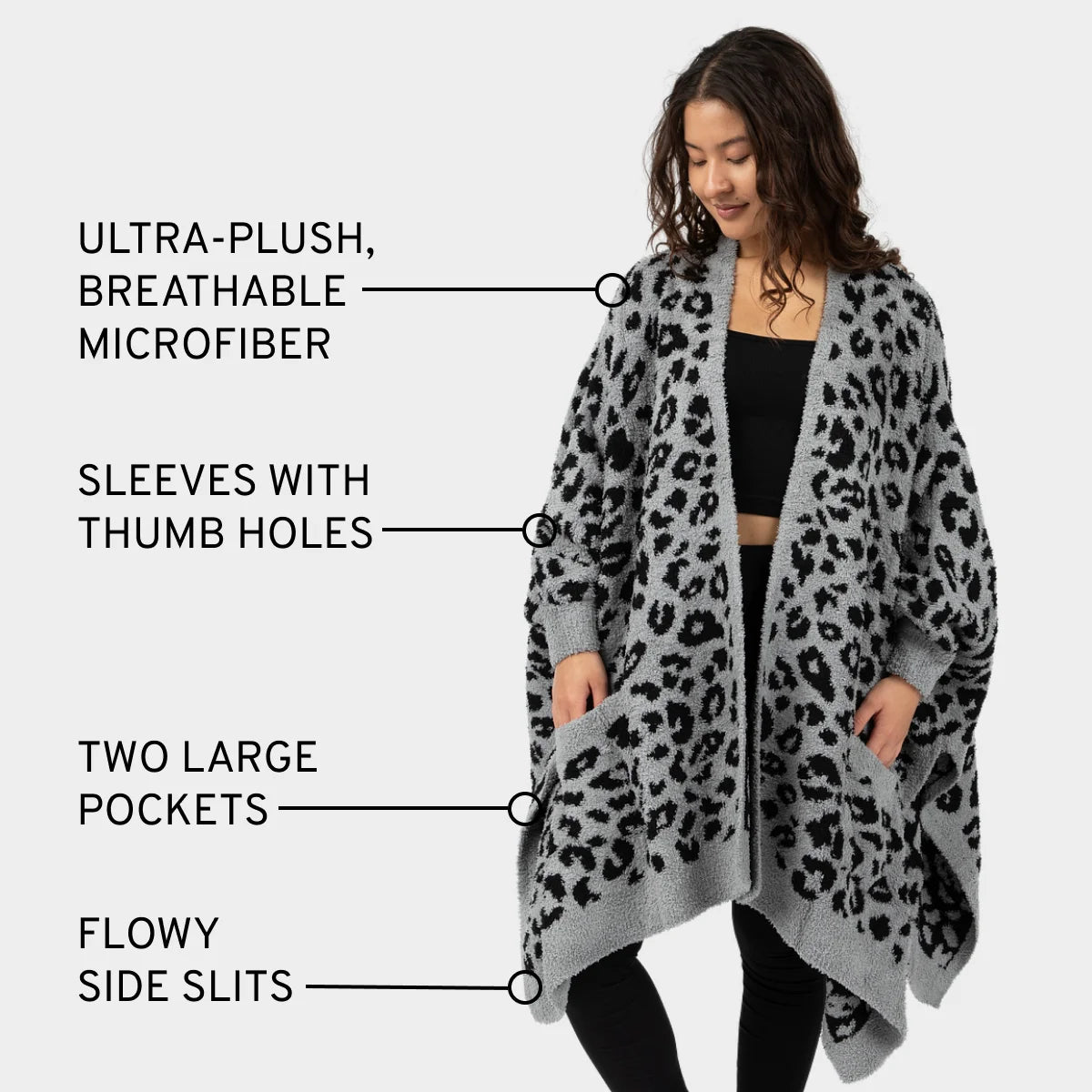 Gray and black leopard print oversized wrap blanket with sleeves and thumb holes worn by woman