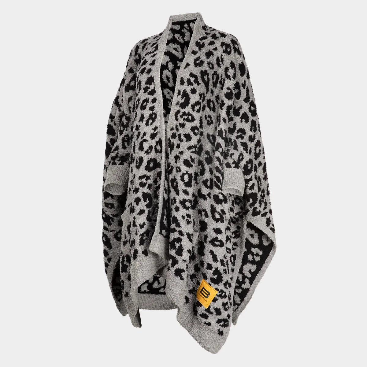 Oversized black leopard print blanket wrap in gray and black, draped with collar and pockets, Big Blanket Co tag visible