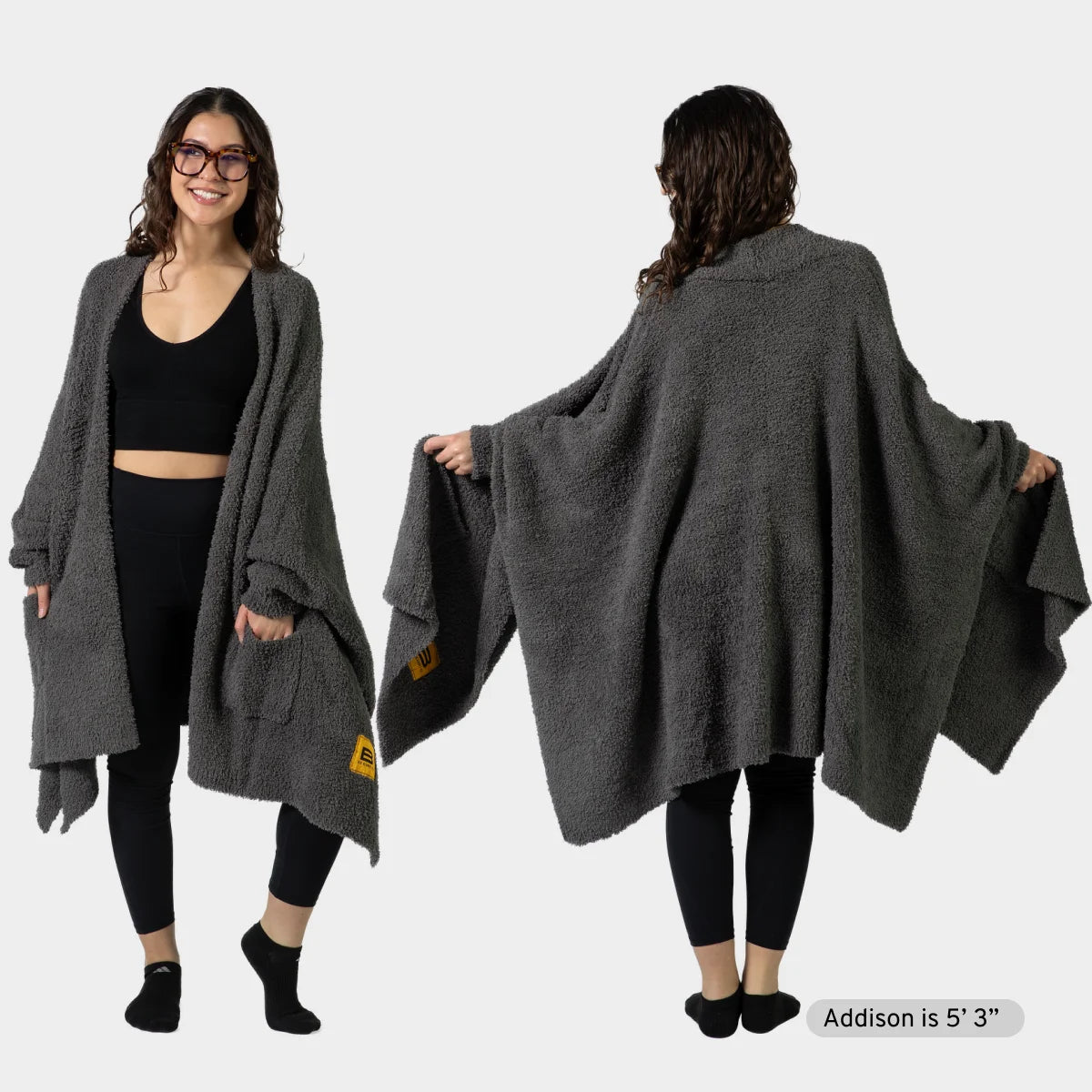 Charcoal Premier Plush wrap draped over woman's shoulders, front and back views, showing oversized cozy blanket design with pockets