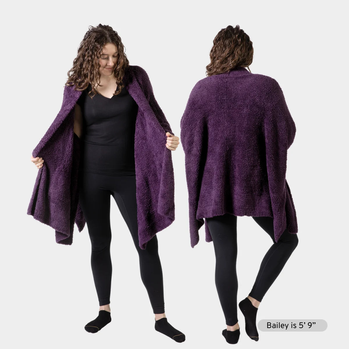 Woman wearing deep purple oversized Premier Plush wrap draped over black clothing, shown from front and back views