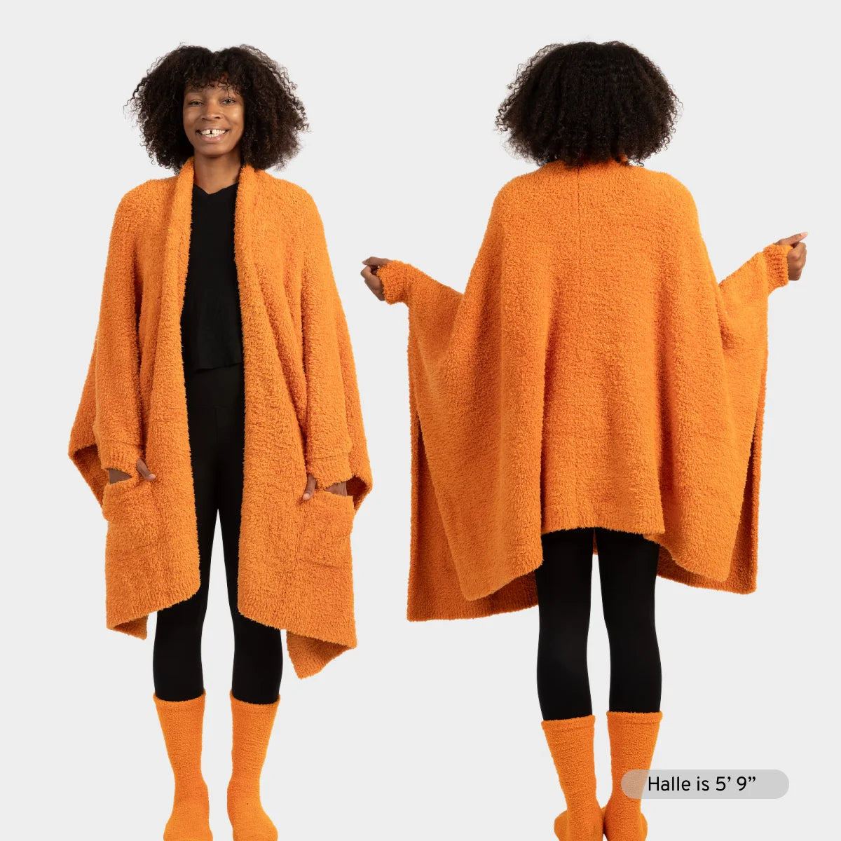 Woman wearing oversized burnt orange Premier Plush Wrap draped over shoulders, front and back view, with matching socks
