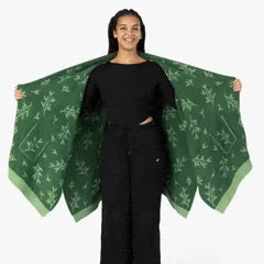 Sage green oversized blanket wrap with darker forest leaf pattern, draped to show texture and size
