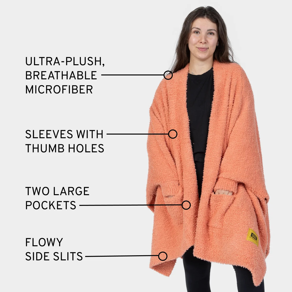 Melon Premier Plush wrap with thumb holes, pockets, and side slits worn by woman demonstrating ultra-plush microfiber design