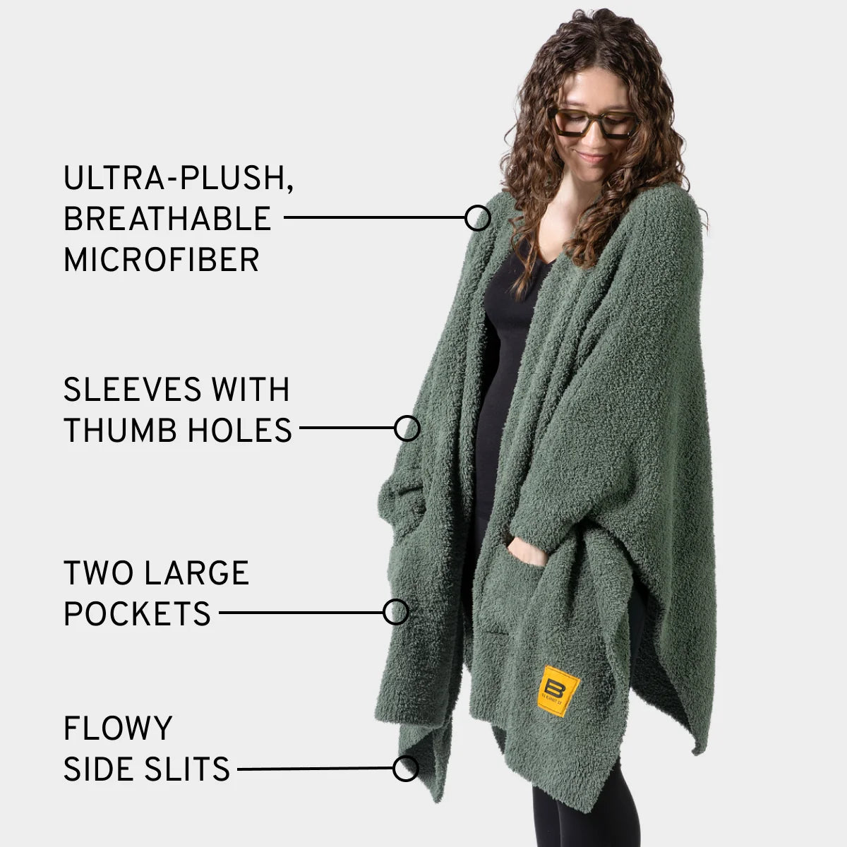 Moss green Premier Plush Wrap with thumb hole sleeves, large pockets, and side slits on model