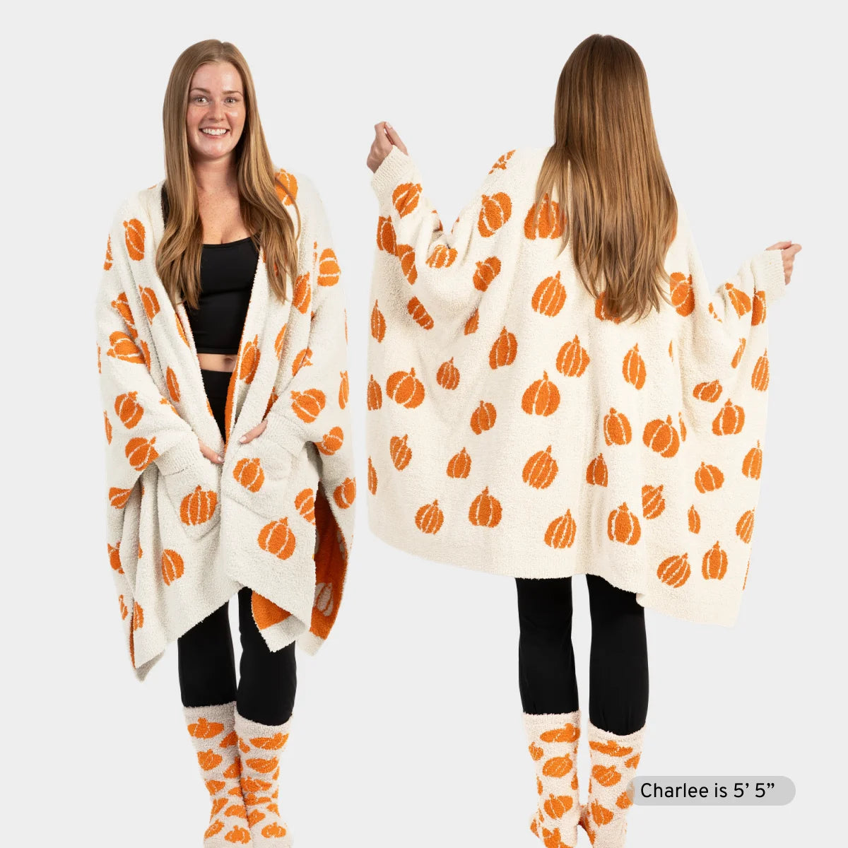 Woman wearing cream Premier Plush Wrap with orange pumpkin pattern draped over shoulders, shown front and back views with matching pumpkin socks