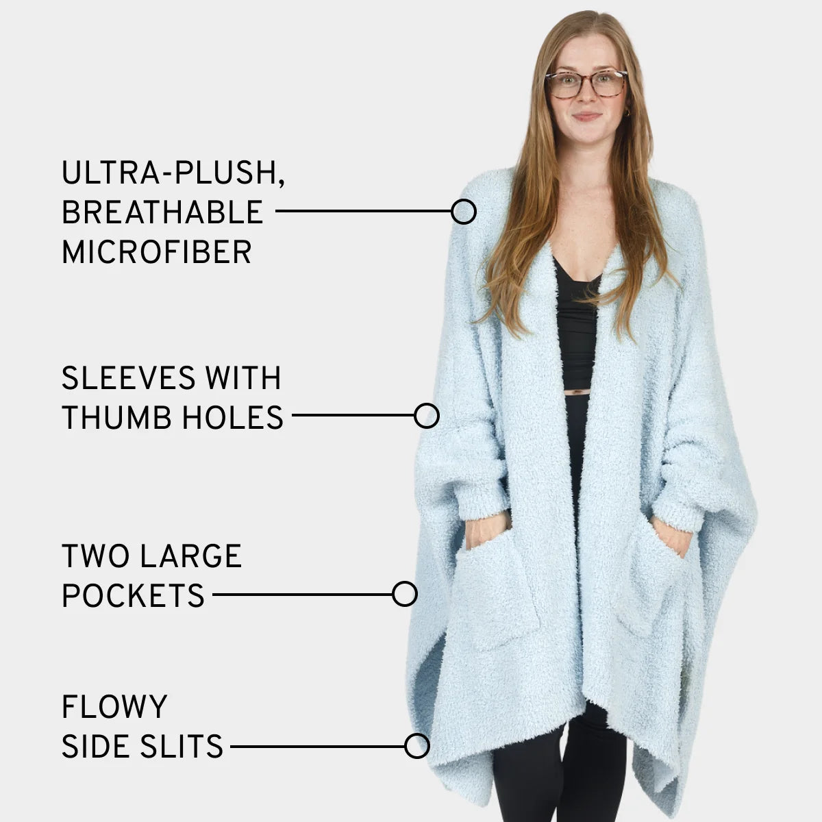 Light blue oversized blanket wrap with thumb hole sleeves, deep pockets, and flowing design worn by woman