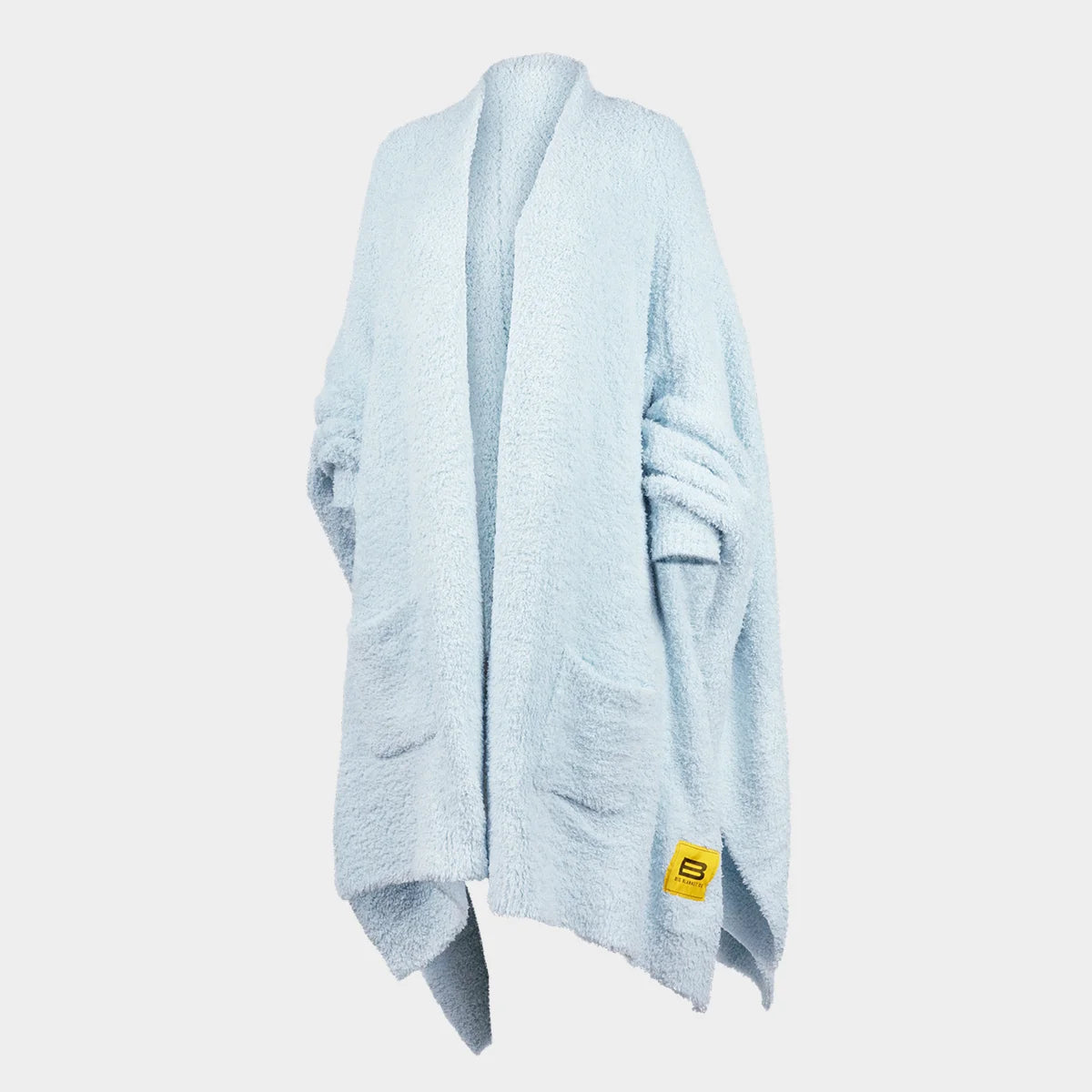 Light blue oversized knit wrap draped on mannequin, showing soft texture and flowing silhouette