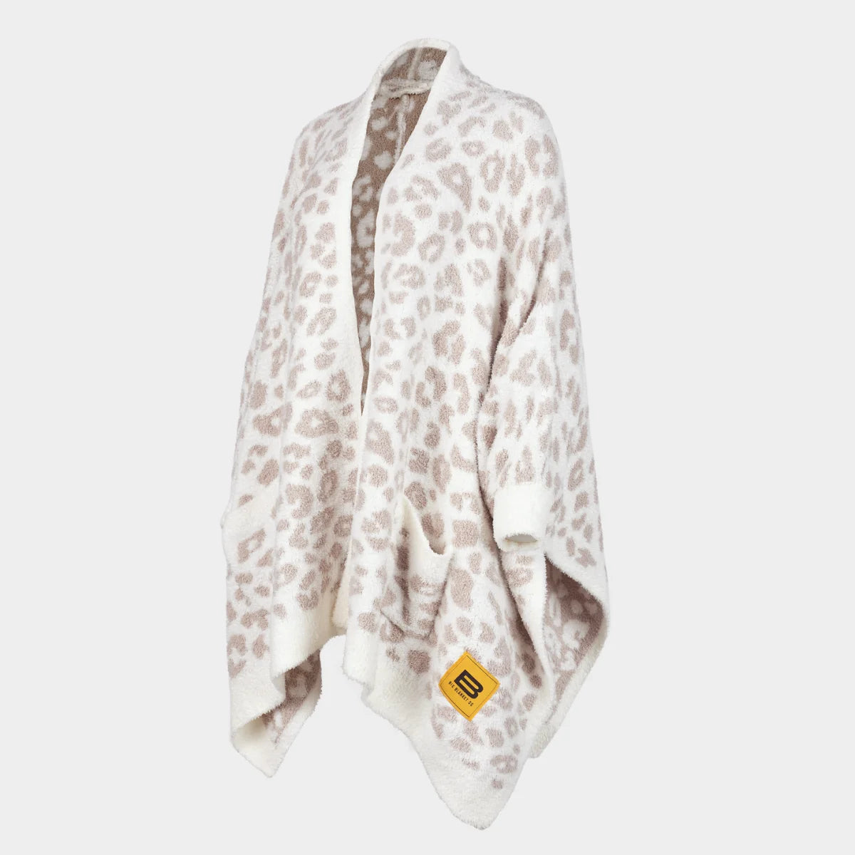 Cream and taupe leopard print oversized blanket wrap draped on figure with gold Big Blanket Co logo tag