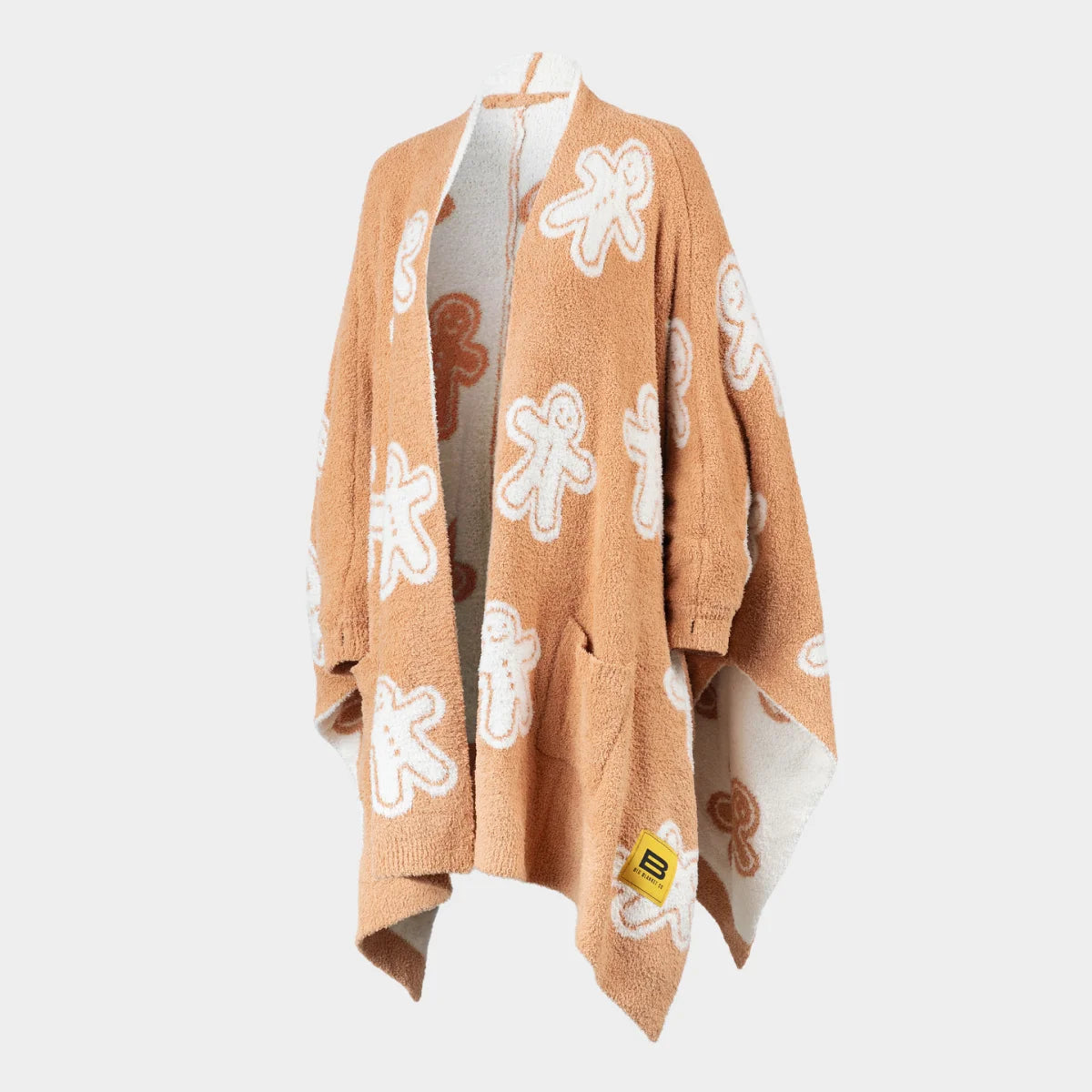 Tan Premier Plush oversized wrap with gingerbread man pattern in white and brown, draped to show reversible cream interior