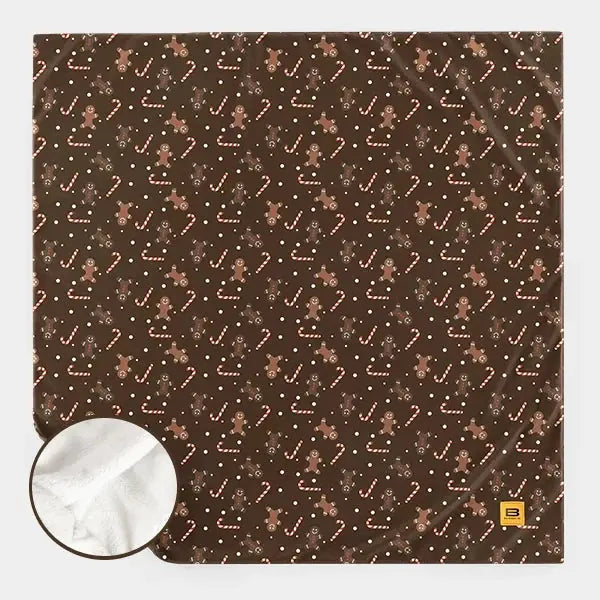 Brown sherpa stretch blanket with gingerbread men, candy canes, and scattered dots pattern