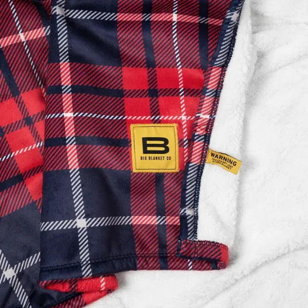 Red, navy and white plaid oversized blanket with sherpa backing and Big Blanket Co logo label